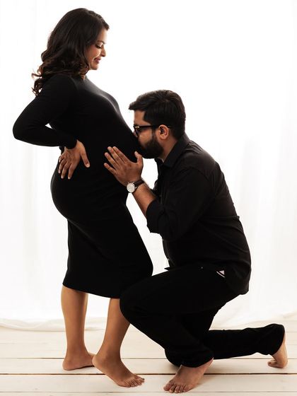 The classic bump kiss. A beautiful way for the father-to-be to show his love and connection to the baby.