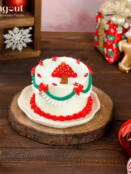 Add a touch of tropical sunshine to your Christmas with our Pineapple Bento Cake. It's decorated with a festive red tree design, offering a bright and fruity alternative for your holiday dessert spread.