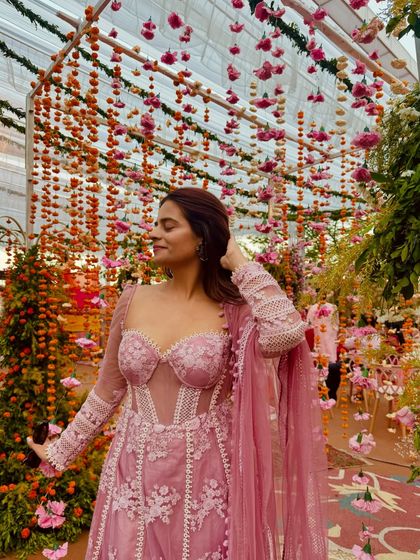 This pink corset Anarkali is a perfect example of modern ethnic wear for pear-shaped bodies. The corset snatches the waist, the puff sleeves broaden the shoulders, and the Anarkali flare flows beautifully over the hips.