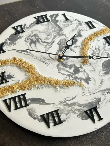 A classic black and white marble clock with gold crystal accents, a timeless design that you can create.