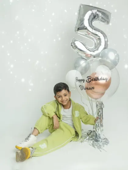 A classic birthday portrait with a personalized balloon. A perfect way to remember this special milestone.