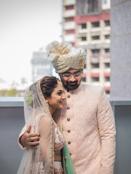 A sweet couple portrait taken on a balcony overlooking the city, a few quiet moments before they say 'I do'.