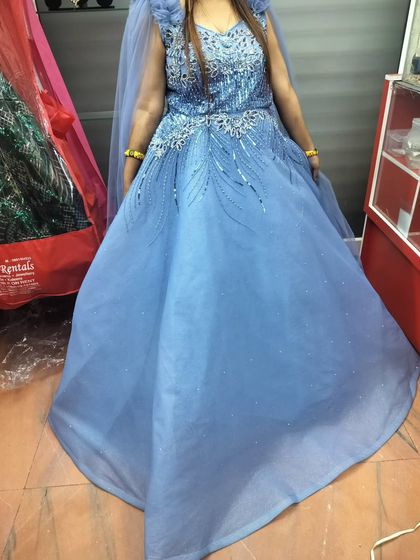 Another shot of the powder blue gown, showing the full skirt. It's a classic ball gown silhouette that will make you feel like a princess.