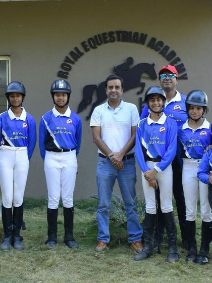 Our team of competitive riders posing with their coach. We are building a community of excellence and supporting each other every step of the way.