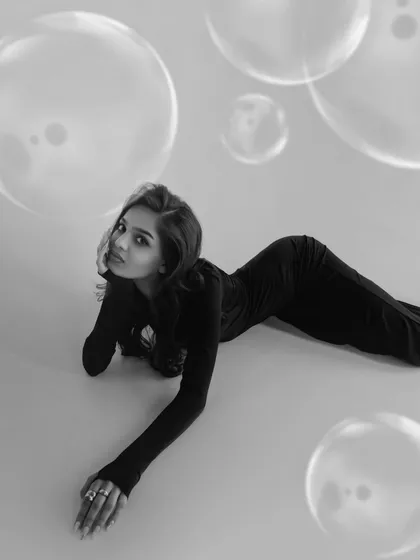 A gentle, reclining pose from the same series. The bubbles floating around the model add to the dreamlike quality of this beautiful black and white photograph.