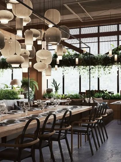 A duplicate of 105, offering another beautiful shot of the main dining area with its lush greenery and modern design.