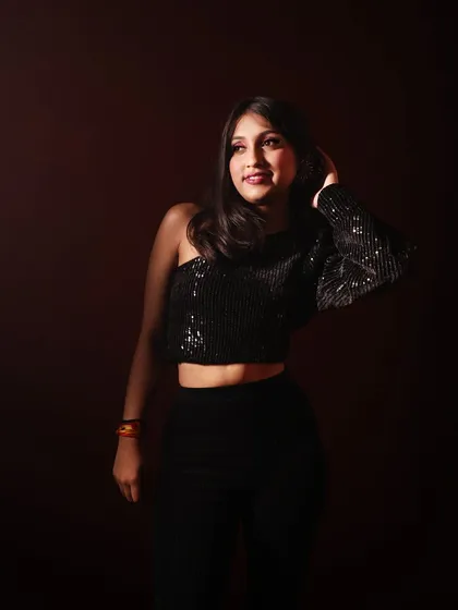 A simple, elegant shot that says 'She's the ONE'. The dramatic lighting highlights my profile and the sequined top.