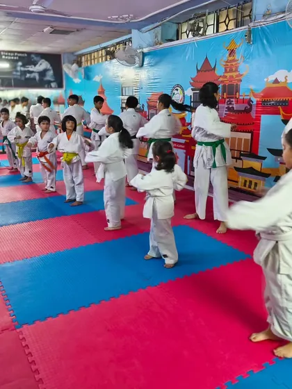 A class of young students lined up and ready for their karate drills. This shows the discipline and structure that is a core part of every training session.