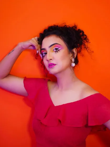 The colorful makeup under dramatic lighting, showing how the pigments pop.
