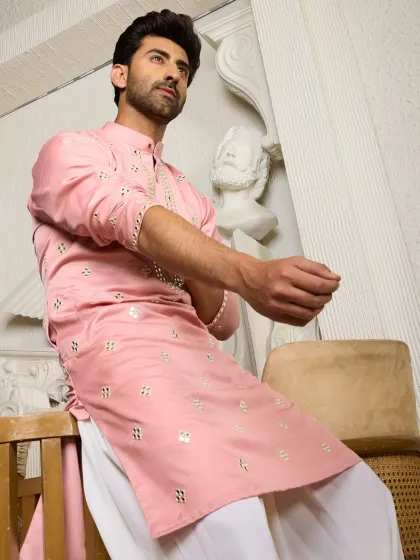 The blush pink kurta with mirror work, shown in a relaxed pose. This piece is designed to be both chic and comfortable, offering effortless glam.