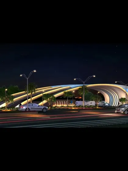 A night-time rendering of a futuristic entrance gate, where architectural form is accentuated by integrated lighting design. The illuminated, flowing structure creates a dramatic and memorable entry point for the campus.