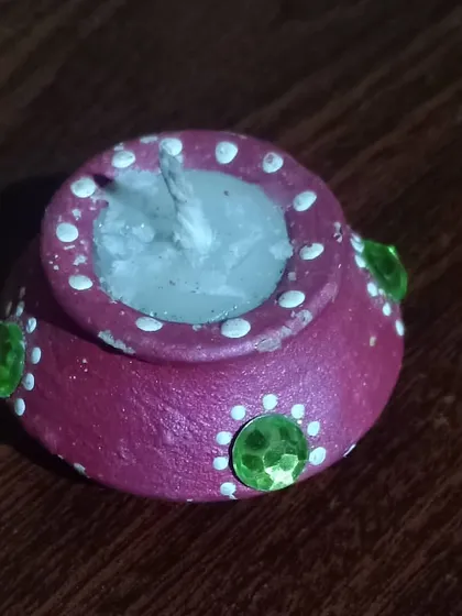 This is one of my handmade decorative diyas, perfect for celebrating an eco-friendly Diwali. Each one is crafted from clay and decorated by hand to support local, traditional artistry.