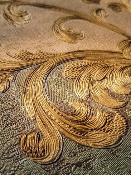 It's all in the details. This close-up reveals the exquisite texture and golden sheen of one of our premium classic designs. Our wallpapers add a layer of depth and luxury that paint simply cannot replicate.