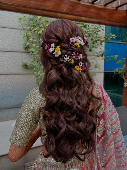 Another angle of the colorful floral half-up style, showing the texture and volume of the curls.