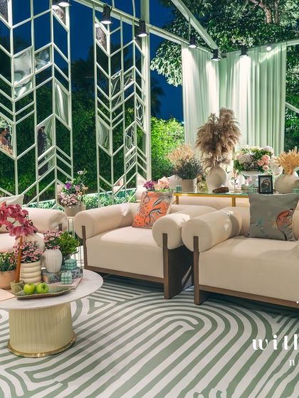 The lounge area of 'The Conservatory' at night, with the mirrored wall reflecting the beautiful decor.