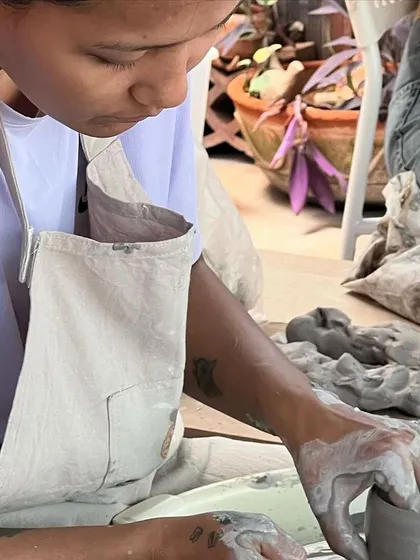 A student fully engaged in her work on the potter's wheel. The studio provides a peaceful escape to focus and create.