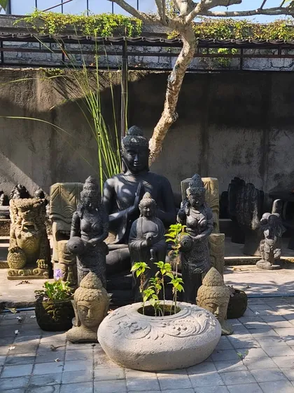 A full setup of Balinese-style stone statues and planters, ready to create a spiritual and tranquil corner in a garden.