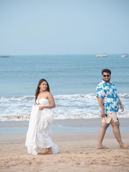 A stylish shot of the couple on the beach in Goa, with a cool color grade that gives it a cinematic feel.