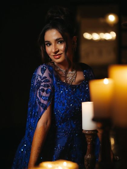 A candlelit portrait of Shree. The deep blue of her gown and the sparkle of the Swarovski crystals create a moody, ethereal vibe for her sangeet night.
