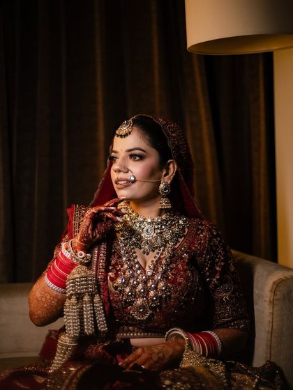 A candid moment of the bride, looking regal and poised. The airbrush makeup ensures her skin looks flawless even in professional lighting.