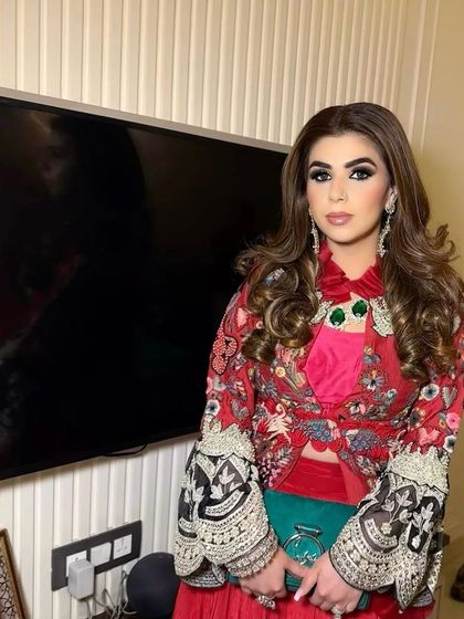 A portrait of a client with her hair in soft, open curls. This hairstyle is perfect for a wedding guest who wants to look elegant and put-together.