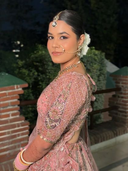 Pretty in pink. Anuja's look was all about soft romance, with a clean makeup look that enhanced her features and a beautiful floral bun.