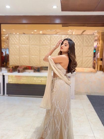 A candid shot of the client showing off her soft waves, a perfect hairstyle for a relaxed yet elegant event.