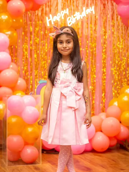 All hearts for this innocence. A beautiful portrait of the birthday girl in her pretty pink dress.