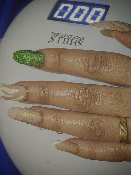 The final set curing under my professional UV lamp. This step ensures the gel polish and extensions are rock-solid and will last for weeks without chipping, locking in the intricate designs.