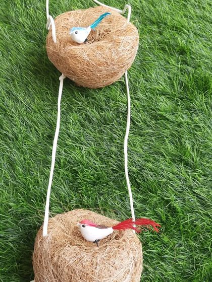 This is a two-tiered hanging bird nest, also made from natural coir. It's a fun design that can accommodate a couple of bird families and adds a lovely decorative element to your balcony.