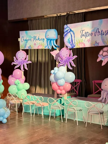 We set up dedicated activity stations for crayon making and tattoos, all themed with cute watercolor sea creatures to keep the little ones engaged and creative.
