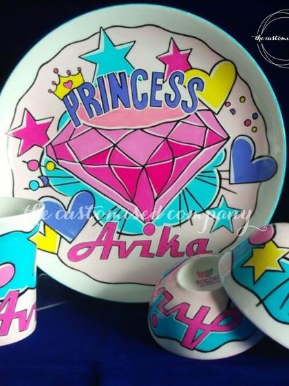 A vibrant, hand-painted 3-piece dinner set for your little princess. This set, including a plate, bowl, and mug, can be personalized with any name and design of your choice.