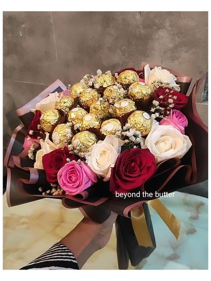 Another view of my chocolate and flower bouquet, featuring a mix of red, pink, and white roses alongside golden Ferrero Rocher chocolates.