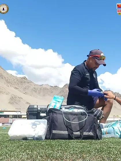 Our physio attending to a player on the pitch in Ladakh. We ensure our players receive immediate and professional medical attention, allowing them to train with confidence.