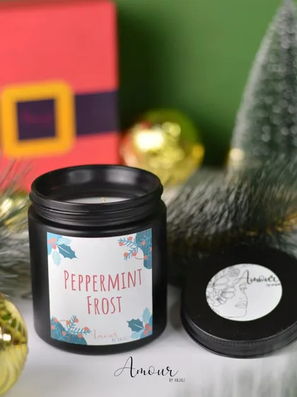 The 'Peppermint Frost' jar candle is perfect for a crisp, refreshing holiday scent. It comes in a sleek black jar, adding a modern touch to your decor.