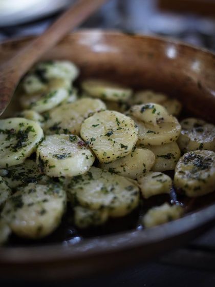 A close-up of our delicious herbed potatoes, a simple side dish elevated with fresh herbs and proper cooking technique.