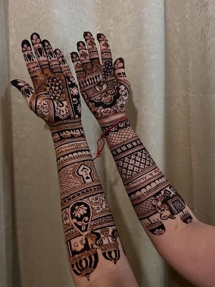 This design is filled with personal touches, including a cute paw print for a beloved pet, elephants, and the couple's initials hidden within the pattern.