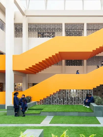 We transform overlooked "in-between" spaces into lively hubs for student interaction. This vibrant orange staircase and multi-level courtyard at SMR Jaipuria School is more than just a way to get from one floor to another; it's a place to pause, connect, and build community.