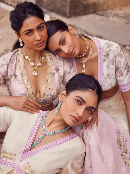 A group shot for a bridal and jewelry campaign, with models styled in soft pastel ensembles. The composition is designed to feel like a painting, showcasing a sisterhood of modern muses adorned in fine jewels and floral couture.
