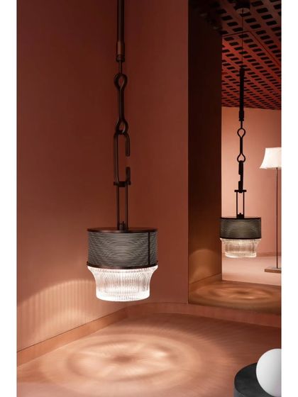 The beauty of this industrial-style pendant is in its detail. We designed the space to allow for close inspection, where the light casts intricate patterns on the floor, adding another layer to the experience.