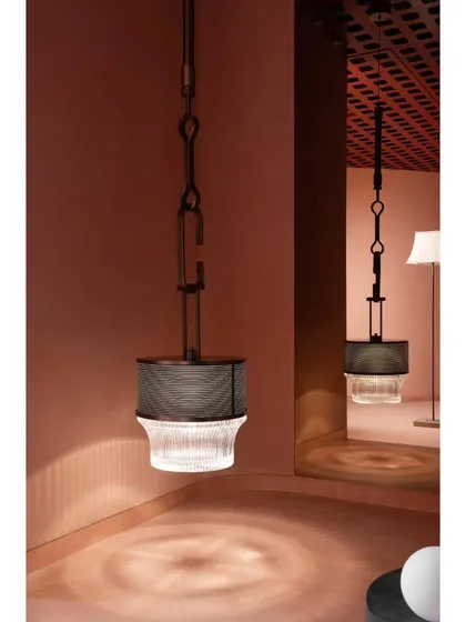 The beauty of this industrial-style pendant is in its detail. We designed the space to allow for close inspection, where the light casts intricate patterns on the floor, adding another layer to the experience.