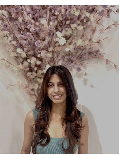 This client is showcasing a trendy butterfly layer cut. This style creates beautiful face-framing layers and adds lots of volume and movement to long hair.