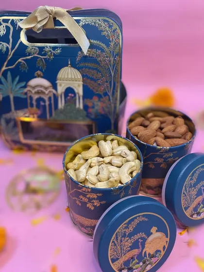 A premium Diwali hamper with two jars of dry fruits, cashews and almonds, in an elegant blue box.