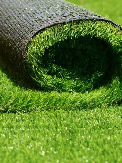 A close-up of a thick 50mm artificial grass roll. The density and height of the blades provide a very luxurious and realistic appearance.