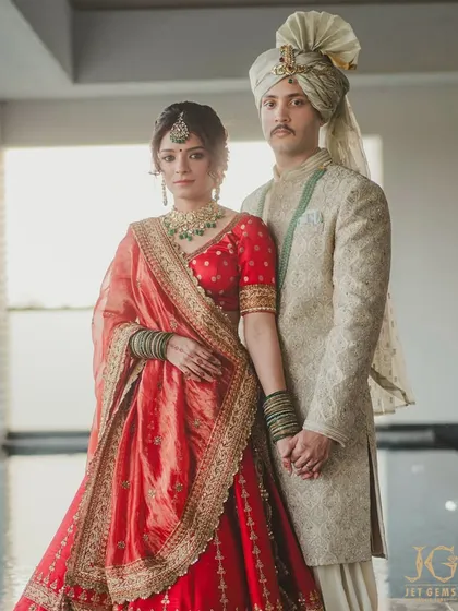 A classic wedding portrait. Maalavika Manoj and her partner, with her traditional green-beaded Polki necklace and maang tikka taking center stage.