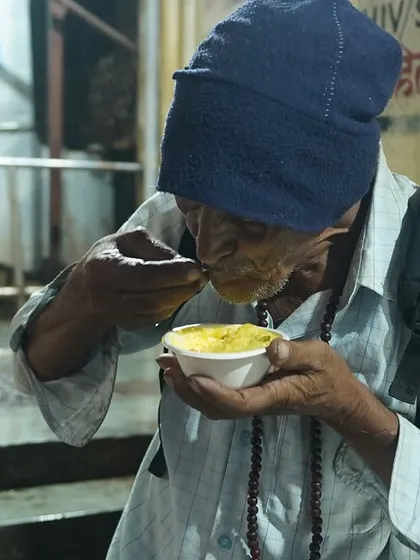 An elderly man eating a meal provided by our initiative. It is a reminder that a simple act of kindness can make a profound difference in someone's day.