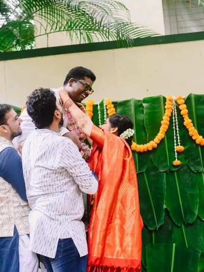 Friends and family helping the groom during the wedding rituals. It truly takes a village, and these moments of support and participation are wonderful to capture.