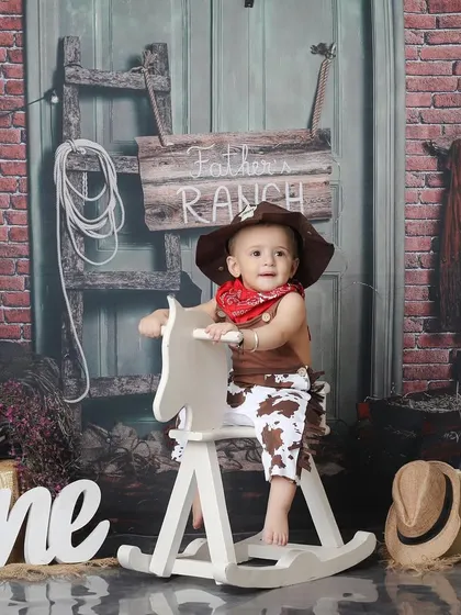 This one-year-old cowboy is ready to ride. Themed shoots like this are a fun way to celebrate a first birthday, and I provide all the props, including the rocking horse and "ONE" sign.