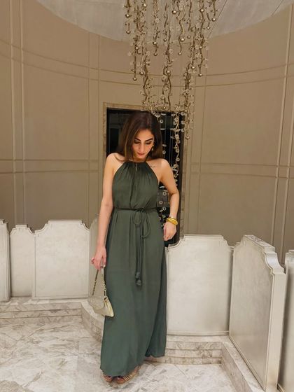 The full look of the green halter-neck dress. The tie at the waist gives it a beautiful shape, and it’s perfect for a resort setting.