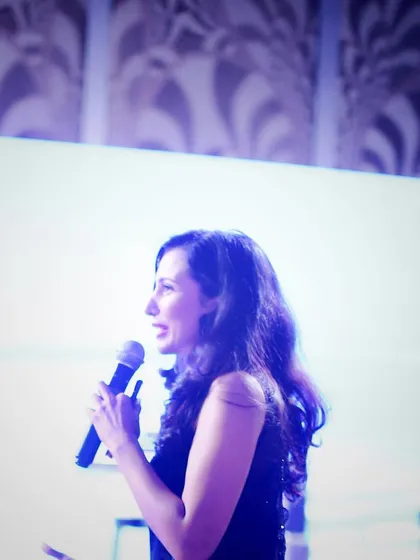 A candid shot while hosting a concert. Whether it's a corporate summit or a cultural evening, the core of my job is to connect with people, hold their attention, and guide them through a memorable experience.